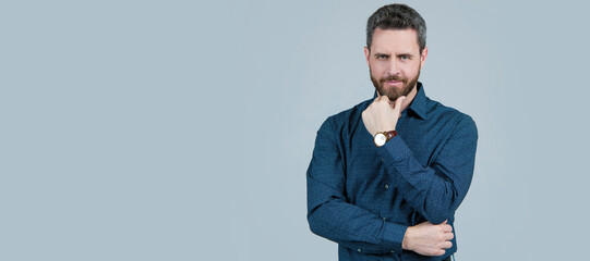 Man face portrait, banner with copy space. Middle-aged unshaven man with serious look touch beard...