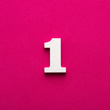 Number 1 - White wooden number on rhodamine red background