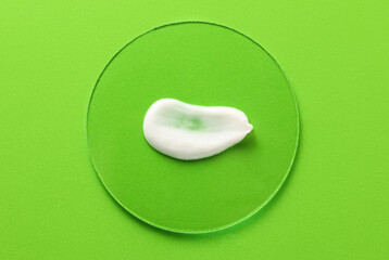 Sample of moisturizing cream on green background