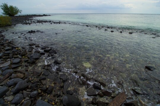 Tropical Beach, Rock, Wave and Blue Sea Water. This photo was taken on one of the tropical islands in Kotabaru, Indonesia.