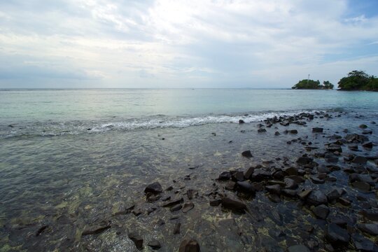 Tropical Beach, Rock, Wave and Blue Sea Water. This photo was taken on one of the tropical islands in Kotabaru, Indonesia.