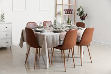 Served table with elegant setting in light room