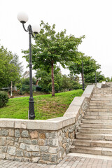 View of beautiful park with steps and lamp