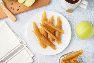 Plate with delicious apple pastilles on light background