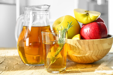 Jug, glass of fresh apple juice and ripe fruits on table, closeup
