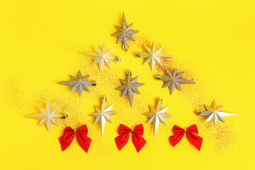 Christmas tree made of beautiful Christmas decorations on yellow background