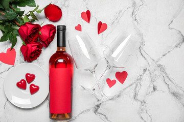 Fototapeta na wymiar Bottle of wine, roses and hearts on grunge background. Valentine's Day celebration