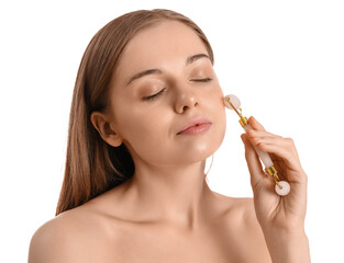 Pretty young woman giving herself face massage with roller on white background