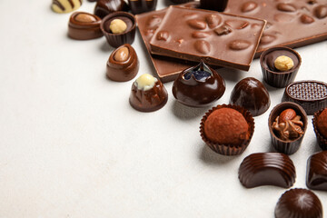 Chocolate bars and candies on white background, closeup