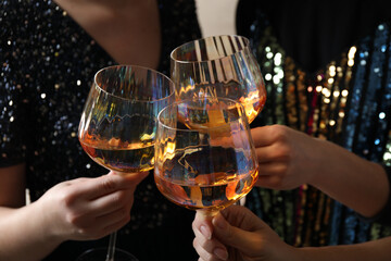 Women clinking glasses with white wine, closeup
