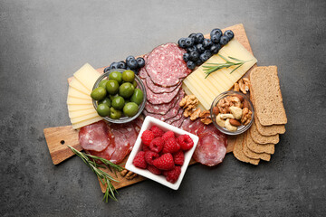 Snack set with delicious Parmesan cheese on grey table, top view
