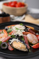 Plate of delicious salad with seafood, closeup view