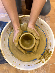 Female hands working with loam, close up. Profession pottery concept.