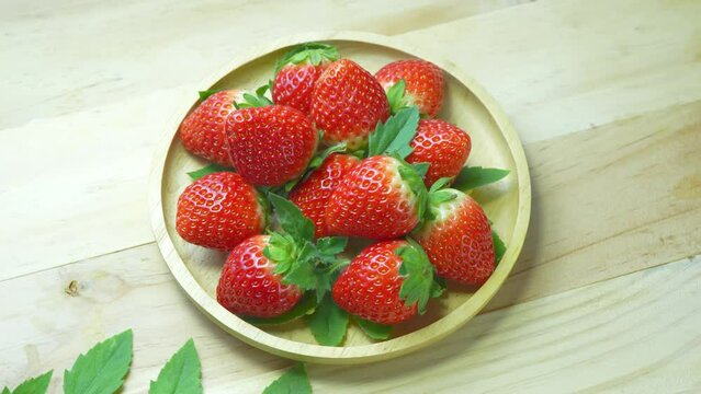 Fresh Red strawberry in wooden plate on wooden background, Korean red Strawberries on wooden Background.