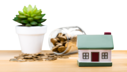 Mini house model and coins in glass
