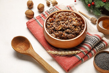 Napkin with bowl of Kutya and ingredients on white background, closeup