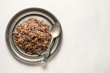 Plate of Kutya and spoon on white background