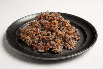 Plate of Kutya on white background