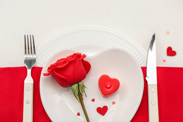 Table setting for Valentine's Day with rose and hearts on white background, closeup