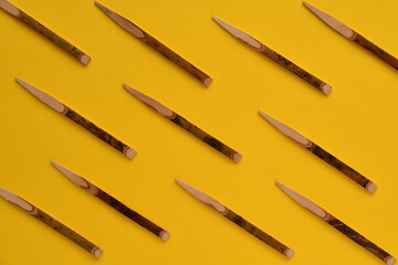 Wooden toothpicks on yellow background