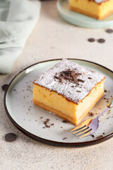 Plate with piece of cheese pie and fork on white table
