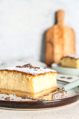 Plate with cheese pie and chocolate on white table