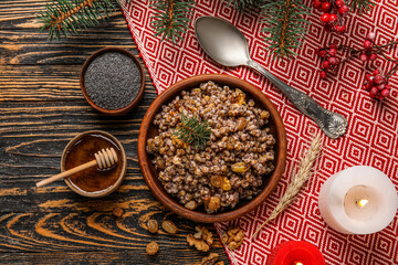 Bowl of Kutya, ingredients and Christmas branches on dark wooden background