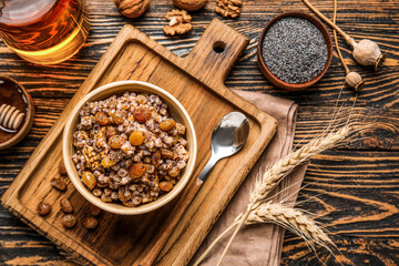 Bowl of Kutya with ingredients and spikelets on dark wooden background