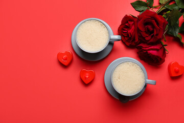 Cups of latte, candles and roses on red background. Valentine's Day celebration