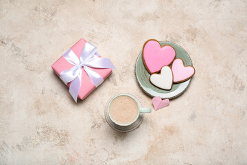 Cup of latte, gift and cookies on grunge background. Valentine's Day celebration