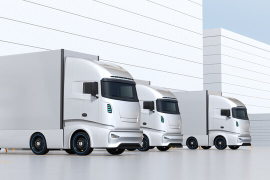 Generic design silver Electric Trucks parking at logistics center.  3D rendering image.