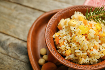 Bowl of rice Kutya on wooden table, closeup