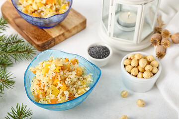 Bowl of rice Kutya and nuts on white table, closeup