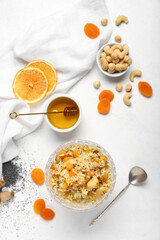 Glass bowl of rice Kutya and ingredients on white background