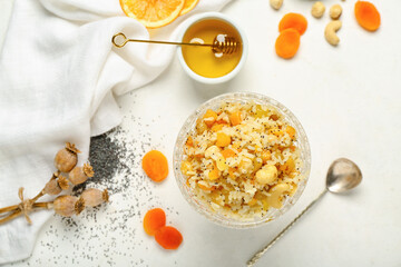 Glass bowl of rice Kutya and ingredients on white background