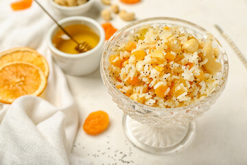 Glass bowl of rice Kutya on white background, closeup