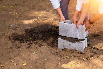 Latino people building future represented with the installation of a block on a vacant lot