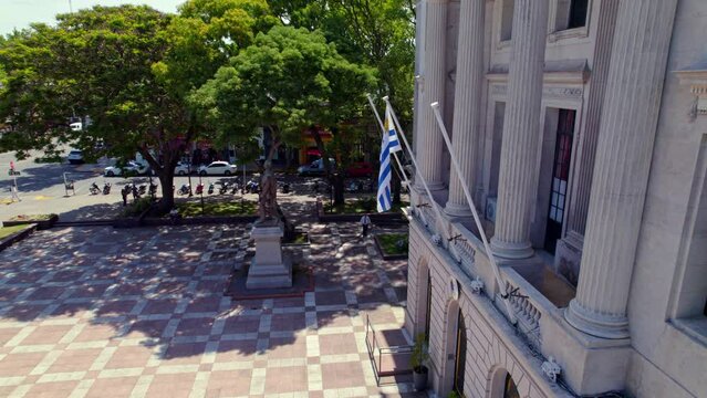 Uruguayan Flag waving on Government Colonial Building, Aerial View on Square Landmark with Trees in Buenos Aires