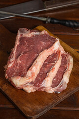 Raw Argentine steaks on a wooden cutting board.