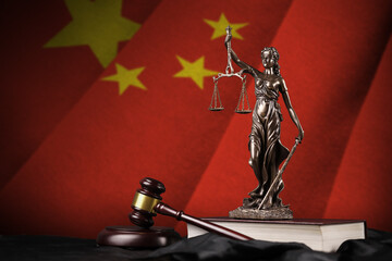 China flag with statue of lady justice, constitution and judge hammer on black drapery. Concept of...