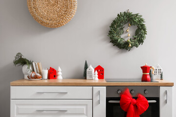 Interior of kitchen with Christmas wreath, oven and bow