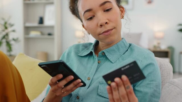 Phone, credit card and finance with woman on sofa for payment, online shopping and investment. Savings, budget and ecommerce with girl customer in living room at home for banking, sale and fintech