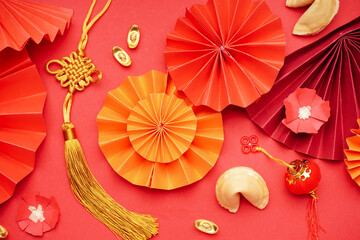 Fortune cookie and Chinese symbols on red background. New Year celebration