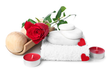 Fototapeta na wymiar Beautiful spa composition for Valentine's Day with massage balls, candles, rose, towel and stones on white background