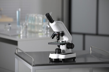 Modern medical microscope on metal table in laboratory