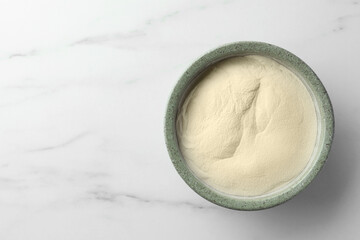 Bowl of agar-agar powder on white marble table, top view. Space for text