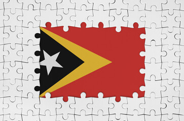 Timor Leste flag in frame of white puzzle pieces with missing central parts