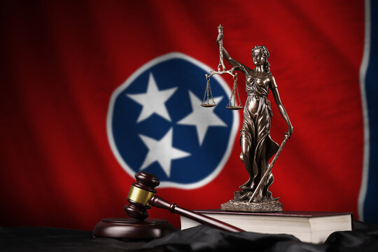 Tennessee US state flag with statue of lady justice, constitution and judge hammer on black drapery. Concept of judgement and punishment