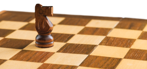 Wooden chess figures on a classic chessboard