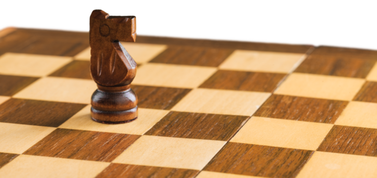 Wooden chess figures on a classic chessboard